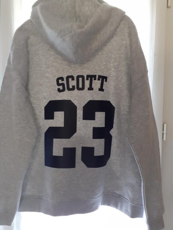 Sweat à capuche gris floqué d'un nom et d'un numéro dans le dos